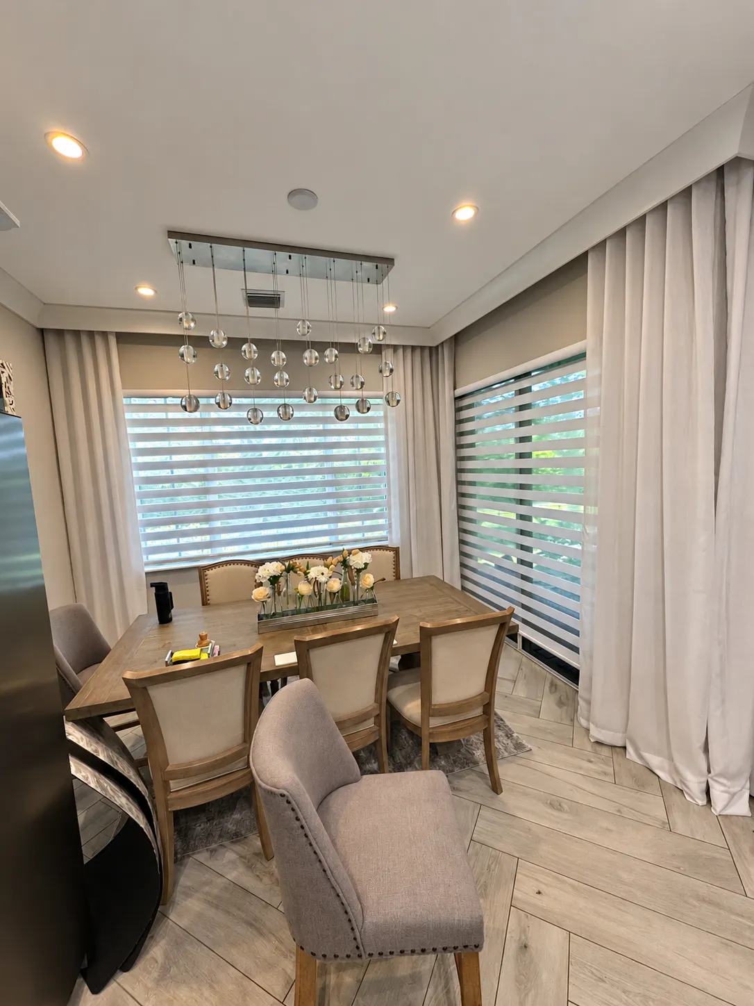 dining-room-zebra-shades-crystal-chandelier-curtains-enhanced